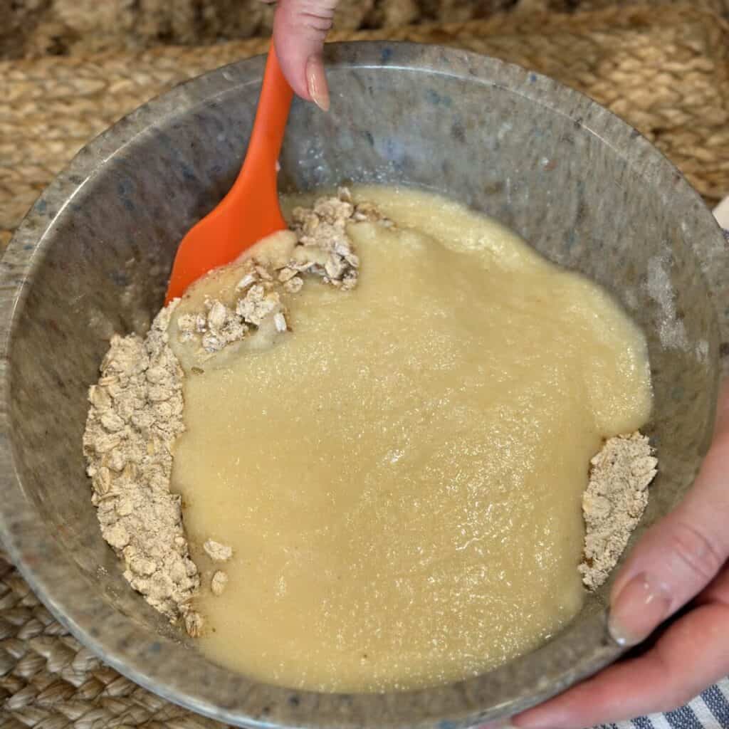 Mixing dry and wet ingredients together in a bowl for muffins.