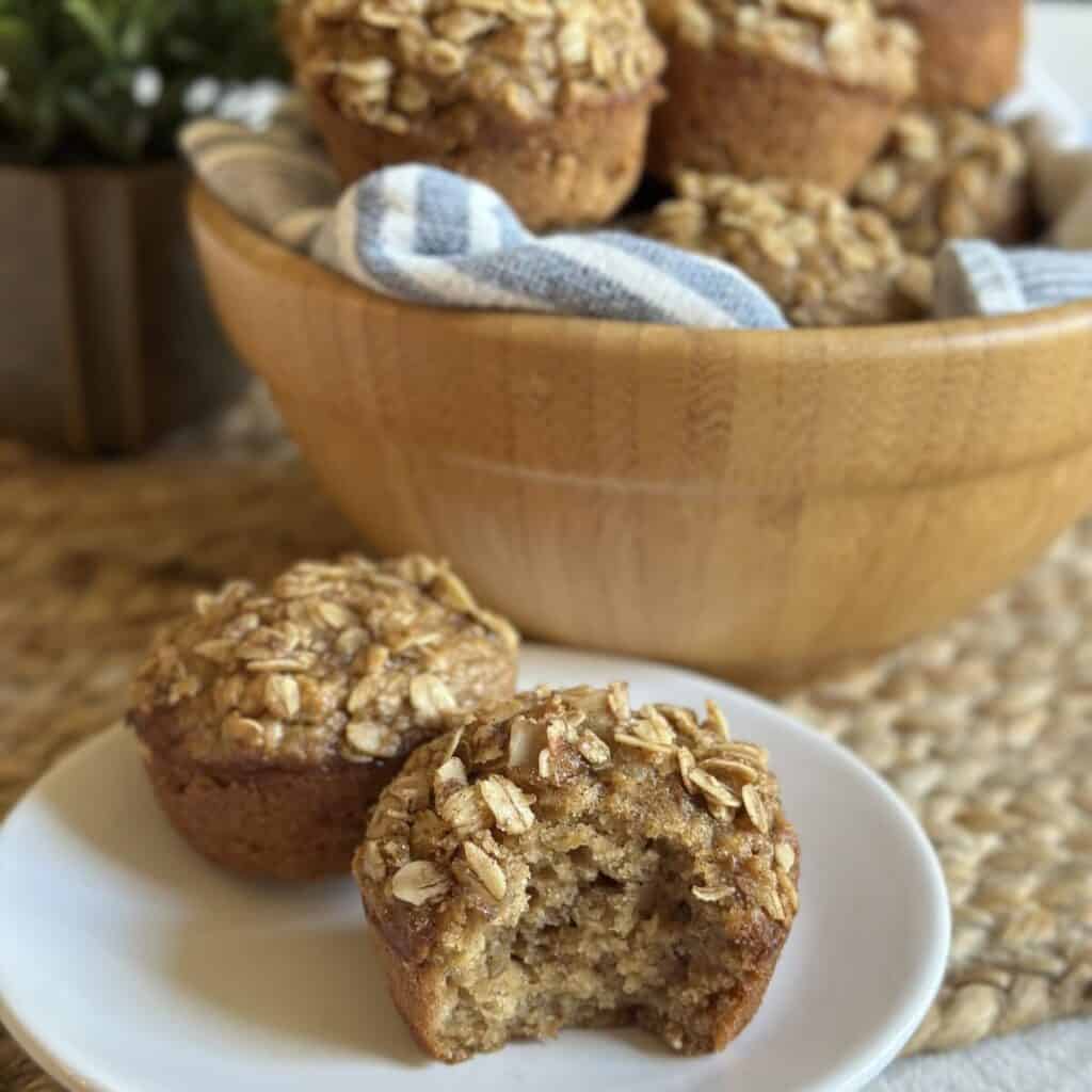 A muffin on a plate that's been bitten