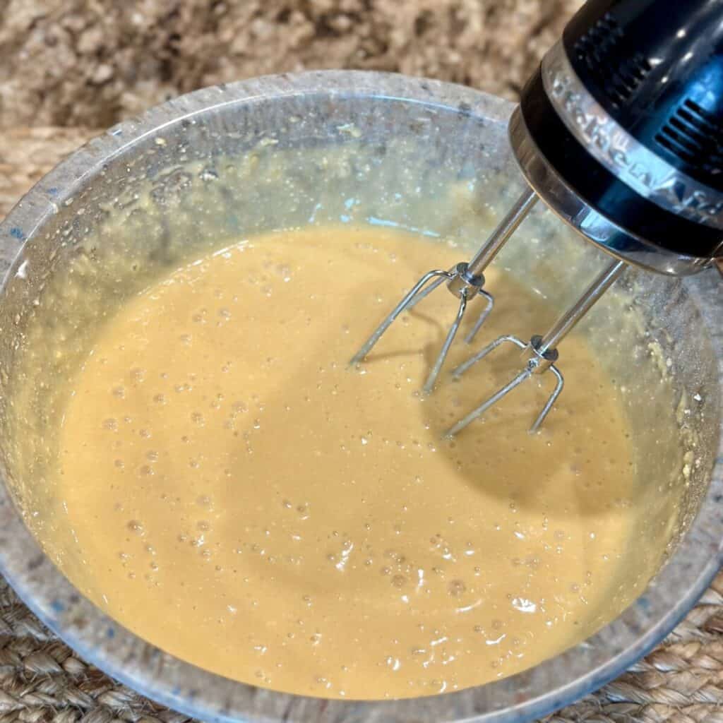 Mixing together a cake mix in a bowl.