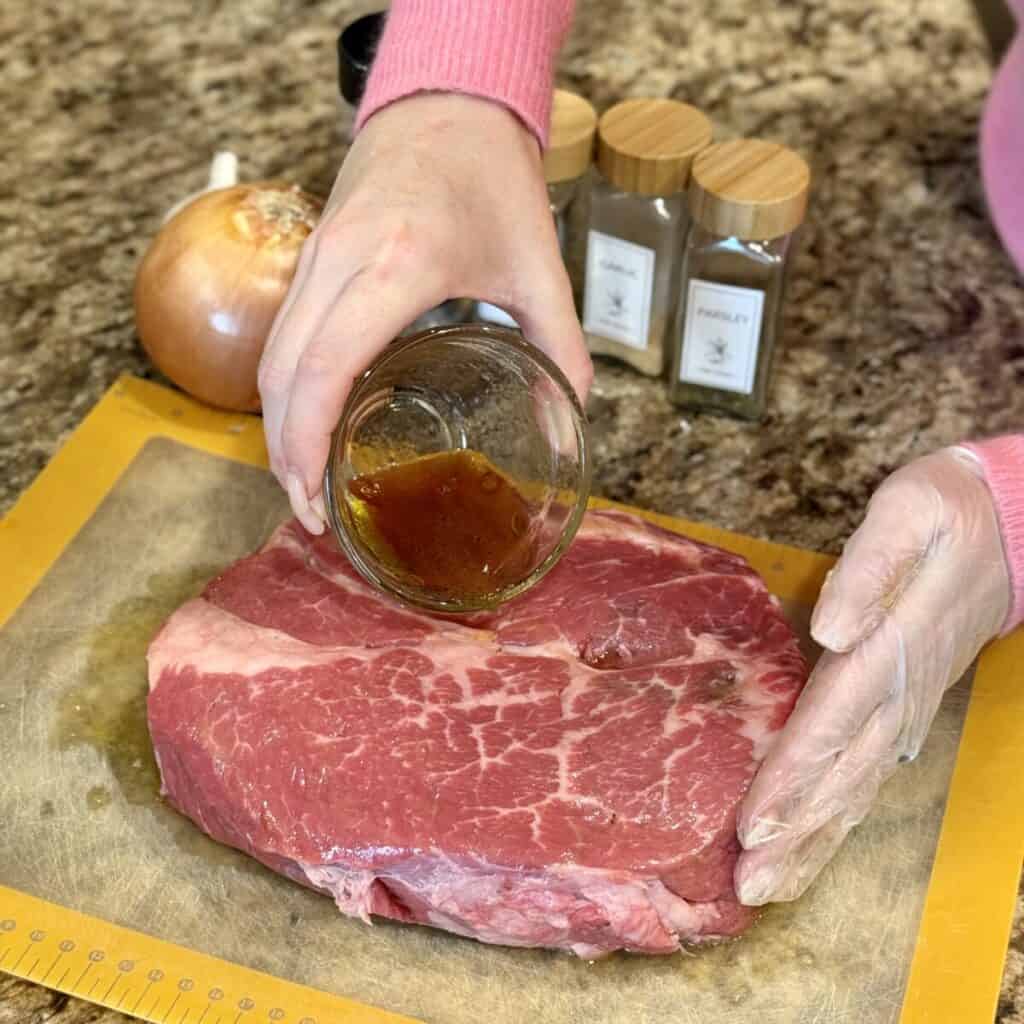 Seasoning a roast on a cutting board.