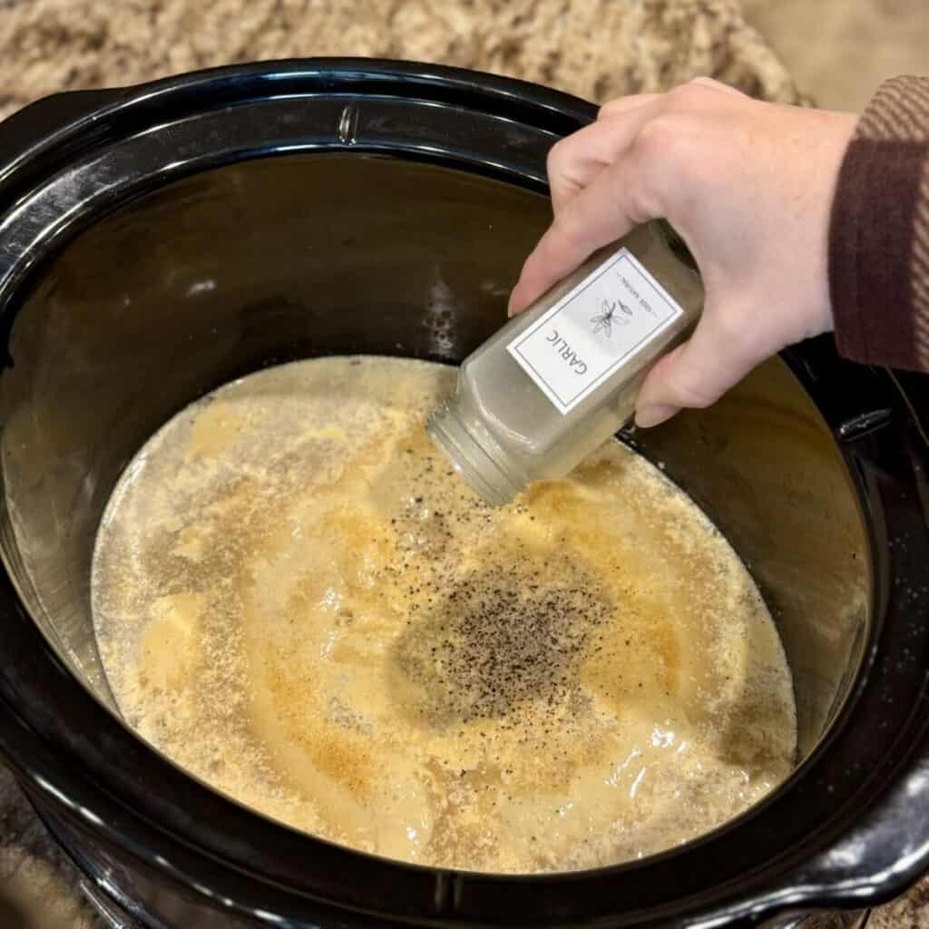 Seasoning broth and honey mustard in a crockpot.