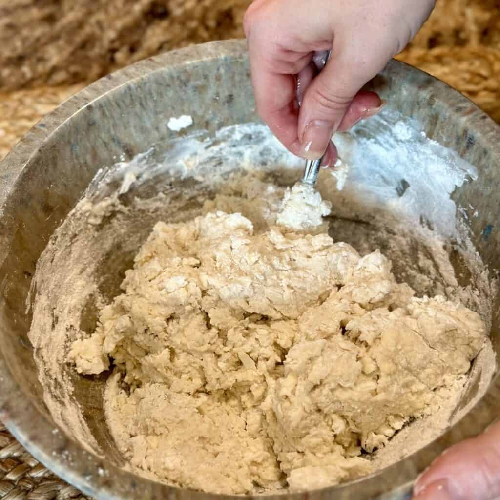 Mixing dough in a bowl.