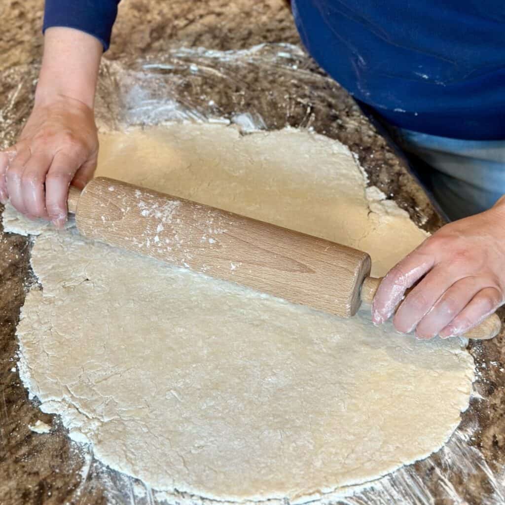 Rolling out dough on a counter.