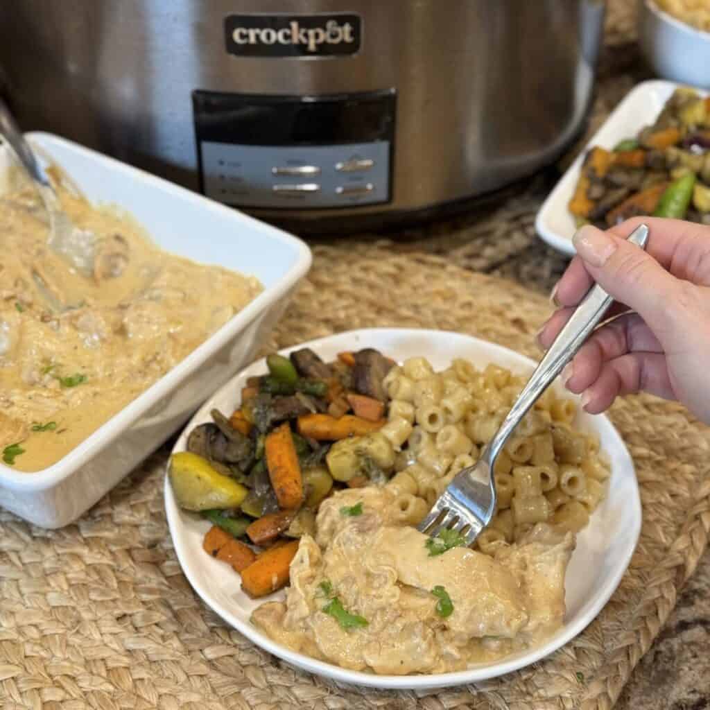 A plate of crockpot honey mustard chicken, vegetables and pasta.