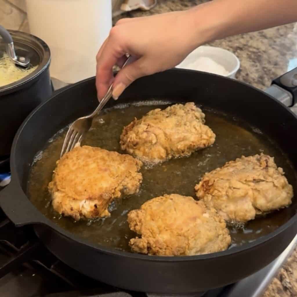 Frying chicken in a skillet.