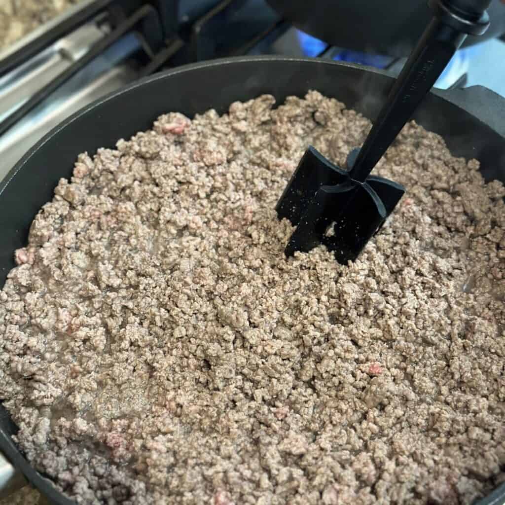 Browning ground beef in a skillet.