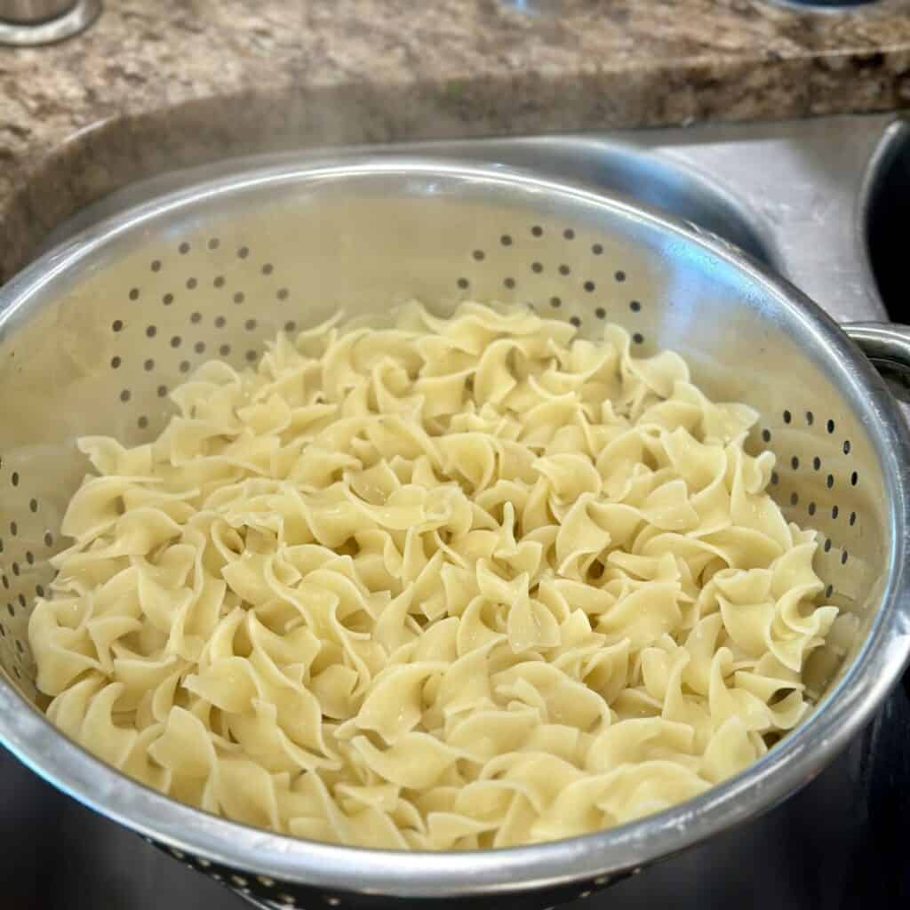 Draining noodles in a colander.