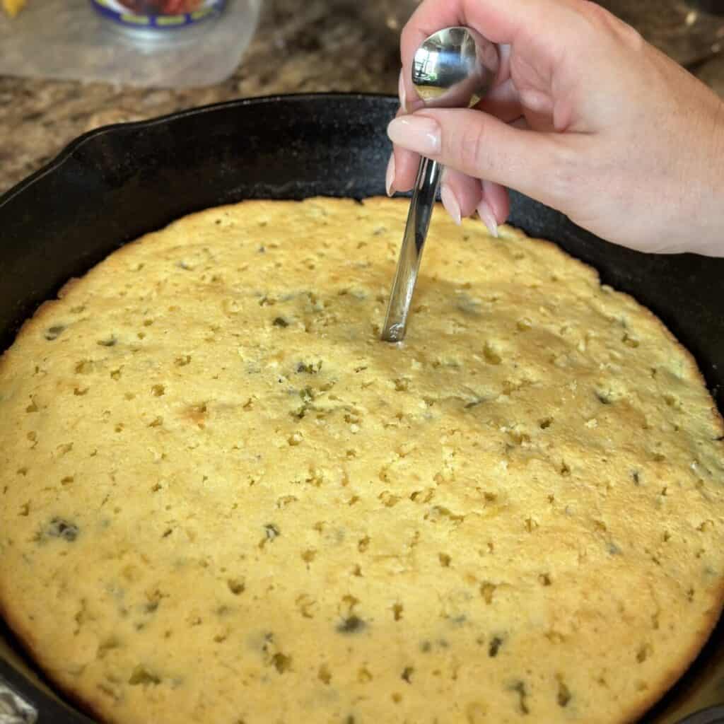 Poking holes in cornbread.