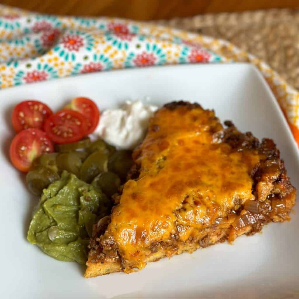 A slice of jiffy tamale pie on a plate.