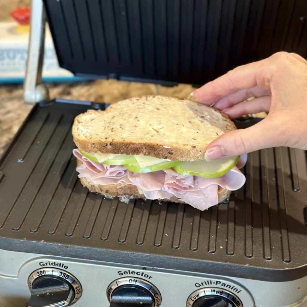 Building a sandwich on a panini press.