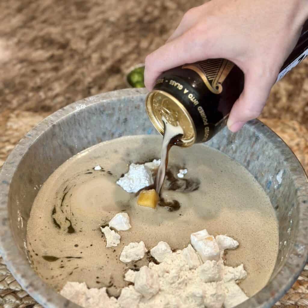 Adding beer to beer bread batter.