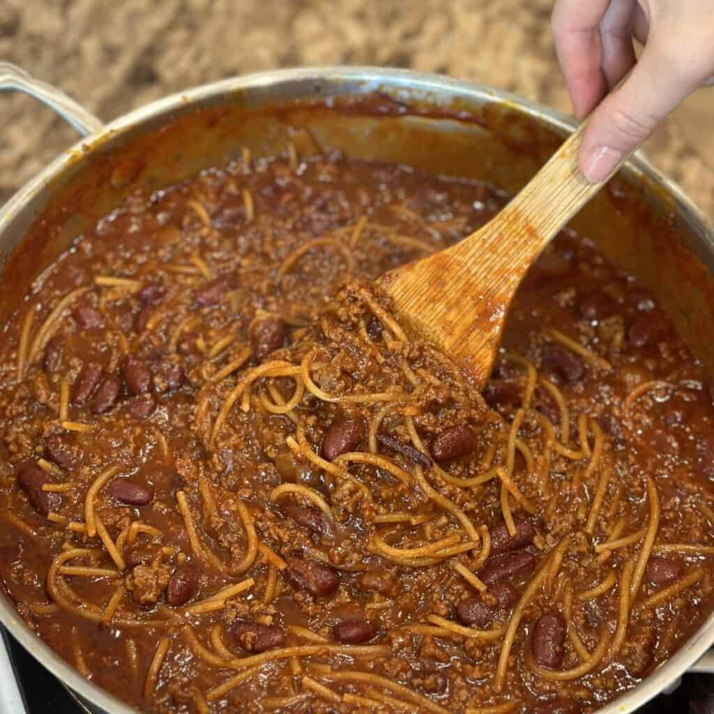 Stirring chili in a pan.