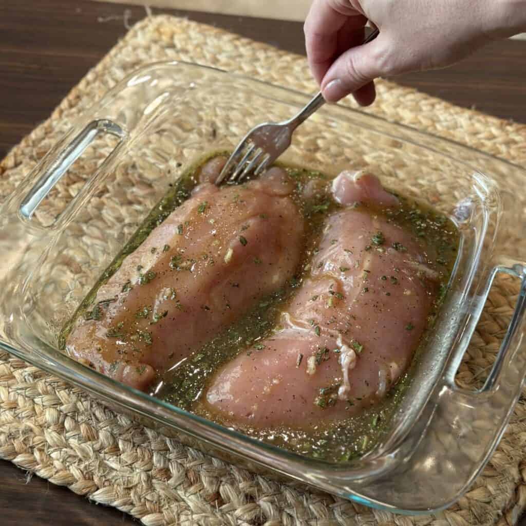 Placing turkey tenderloins in marinade.