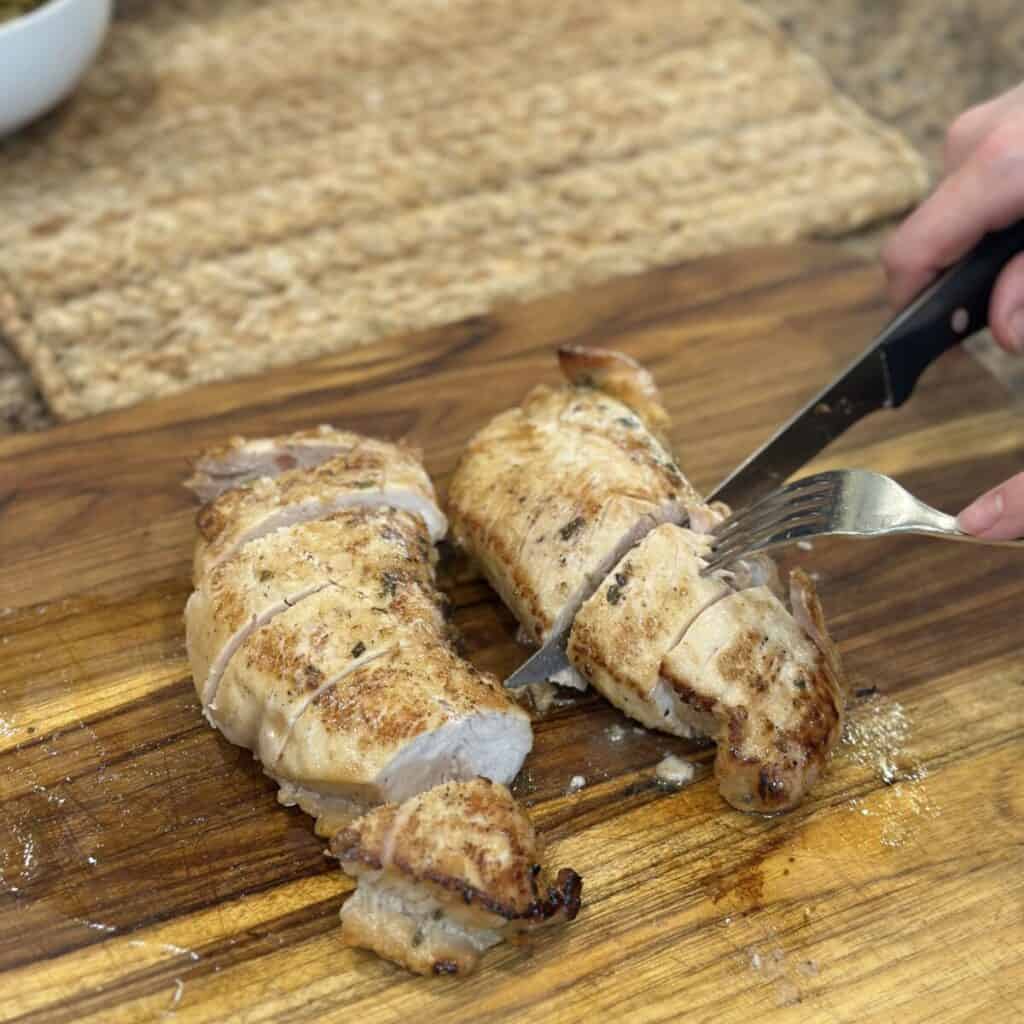 Slicing turkey tenderloins.