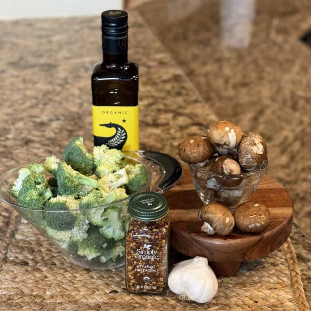 The ingredients to make sautéed broccoli and mushrooms.