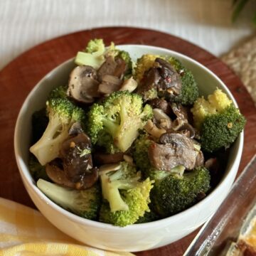 A bowl of sautéed broccoli and mushrooms.