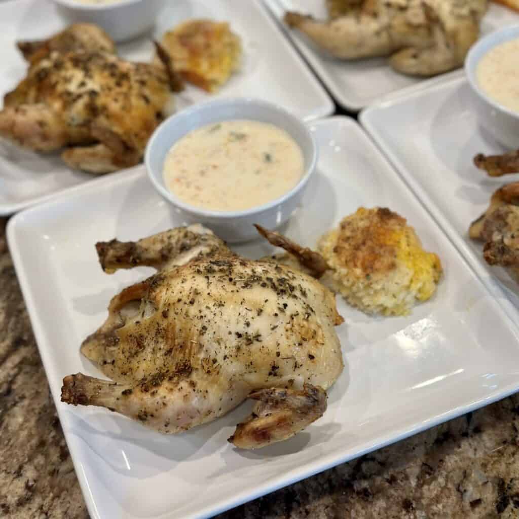 A plate inspired by a meal at Dixie stampede including chicken, soup and a garlic cheddar biscuit.