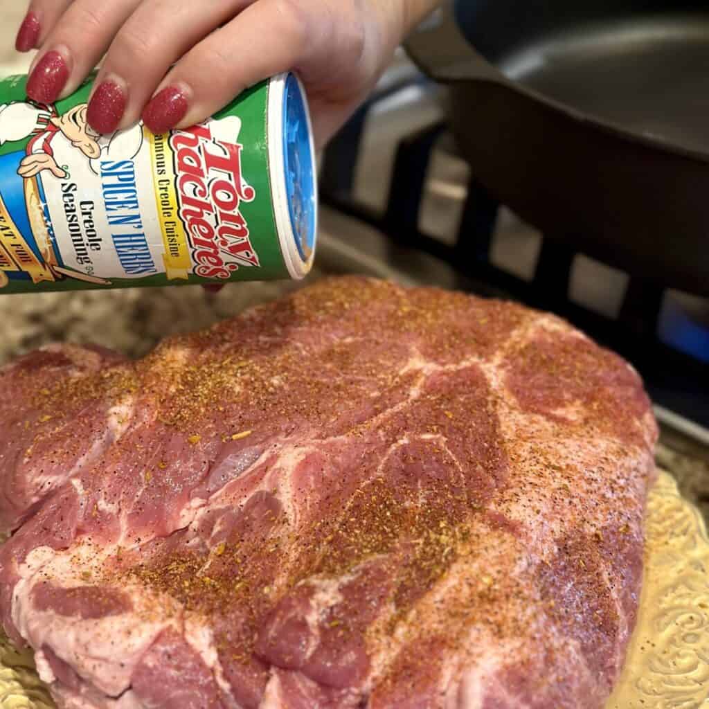Seasoning a pork roast.