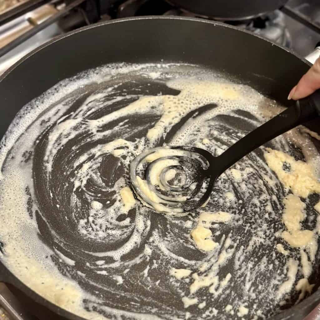 stirring together butter and flour in a skillet.