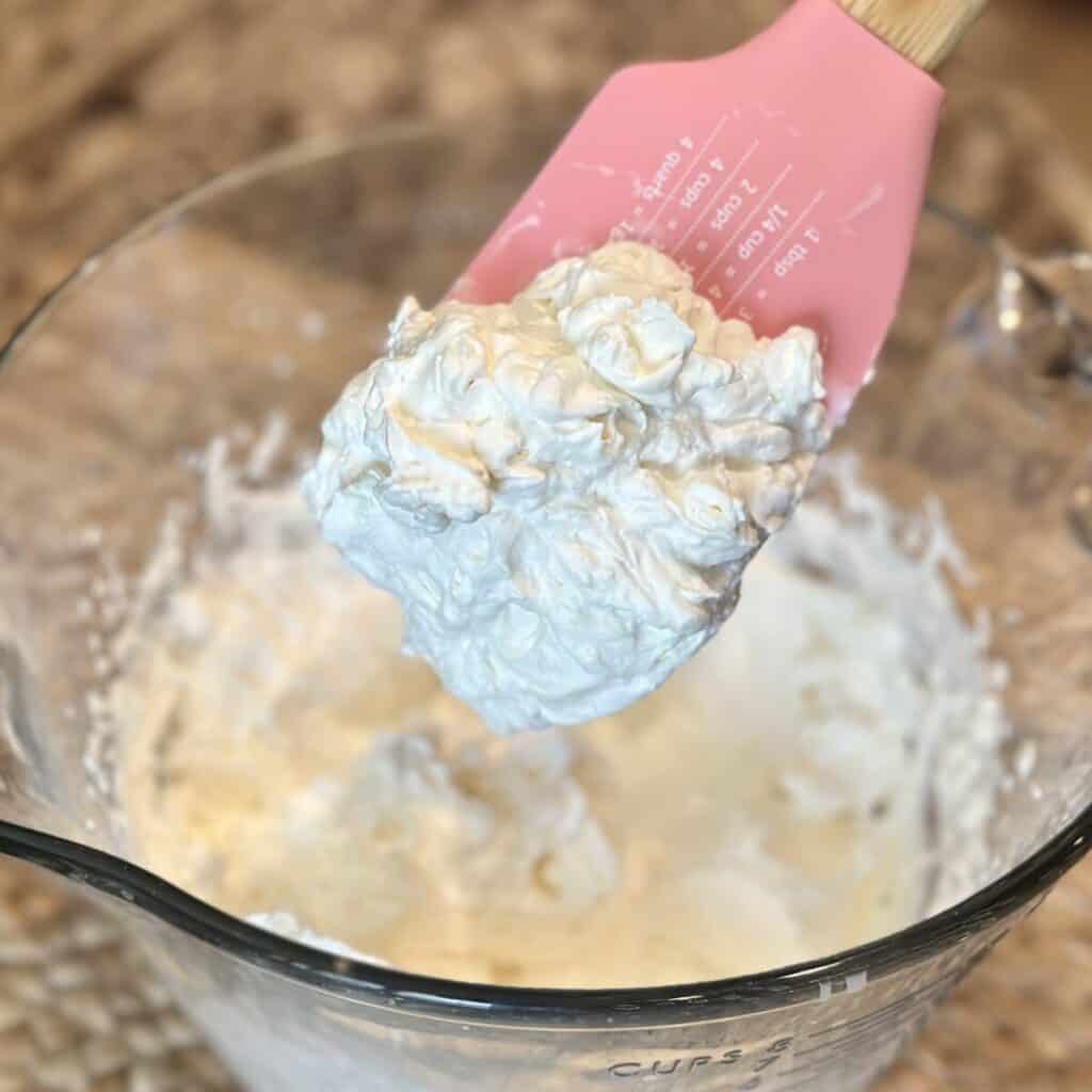 Whipping cream on a spatula.