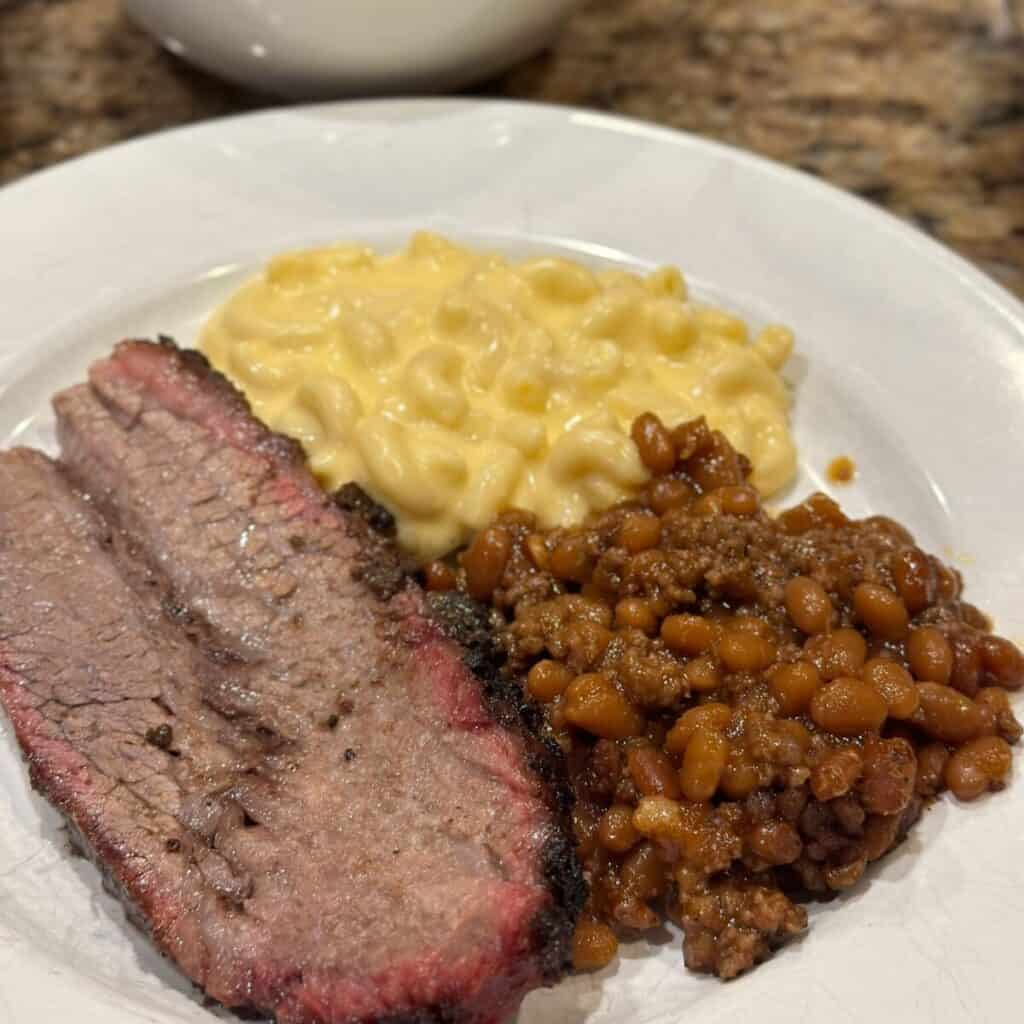 Ground beef baked beans with beef and Mac and cheese on a plate.