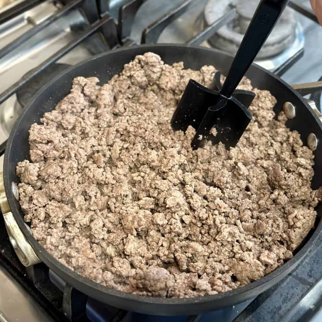 Browning beef in a skillet.