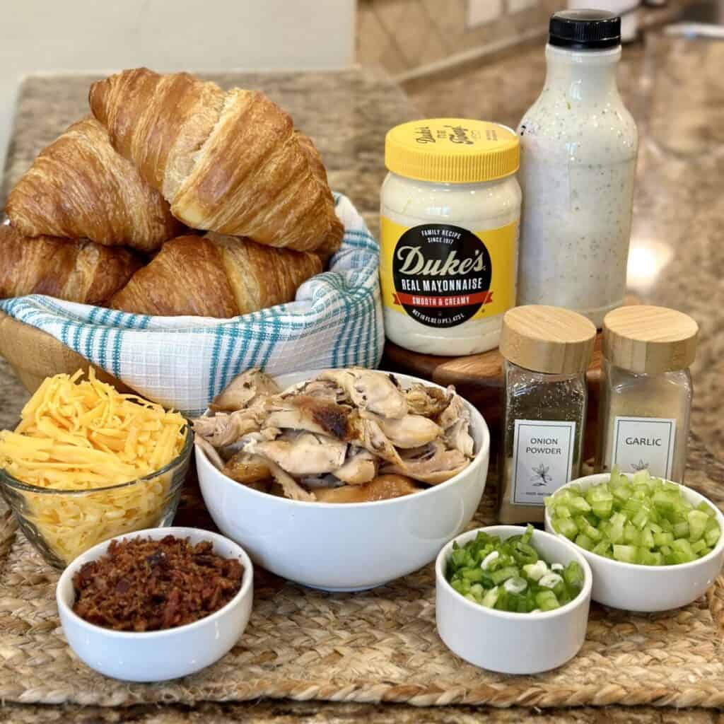 The ingredients to make a chicken salad croissant.