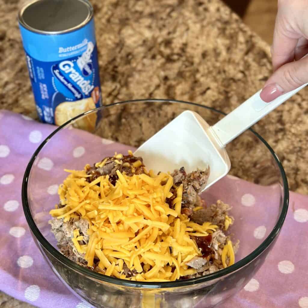 Mixing the filling for barbecue cups in a bowl.