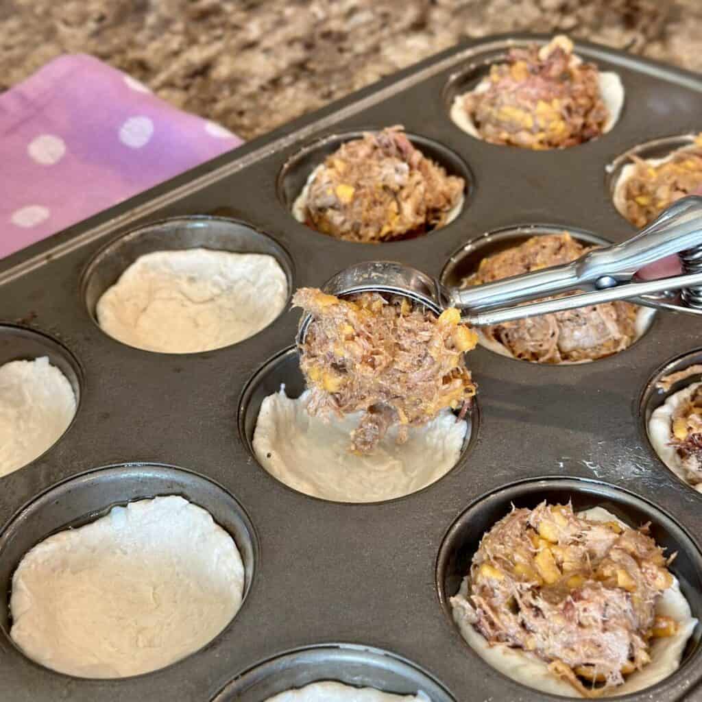 Add meat filling to biscuit dough.