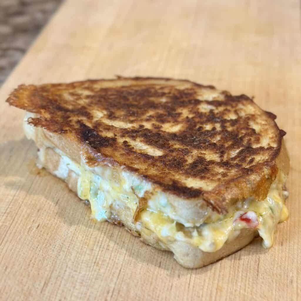 A grilled pimento cheese on a cutting board.