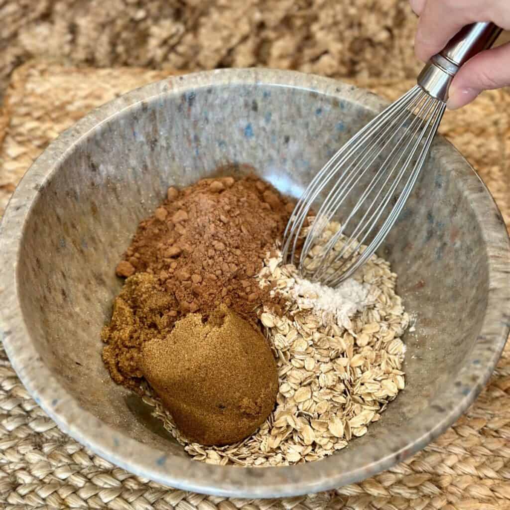 Mixing the dry ingredients for baked chocolate oatmeal.