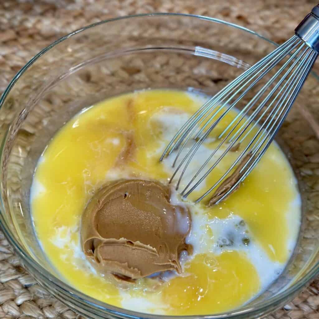 Mixing the wet ingredients for baked chocolate oatmeal.