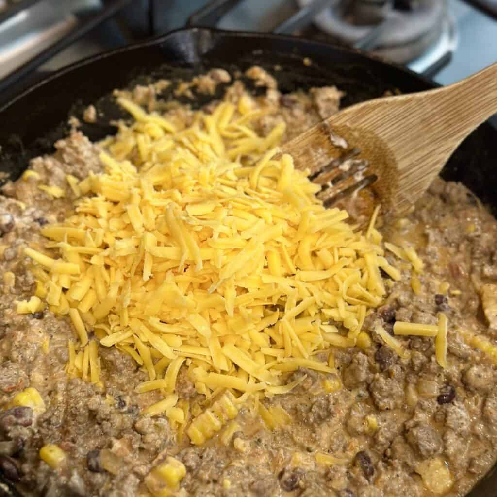 Folding cheese in ground beef.