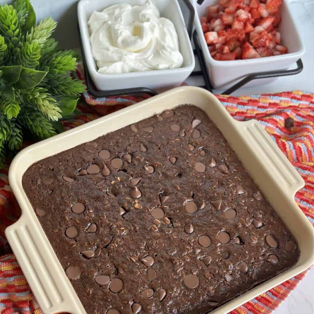 Baked chocolate oatmeal with berries and cream.