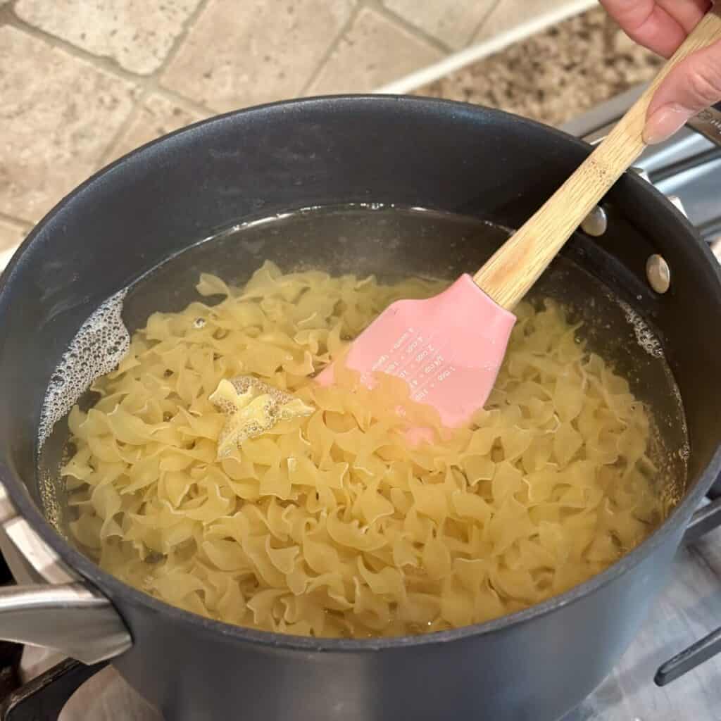 Cooking noodles in a pot of water.