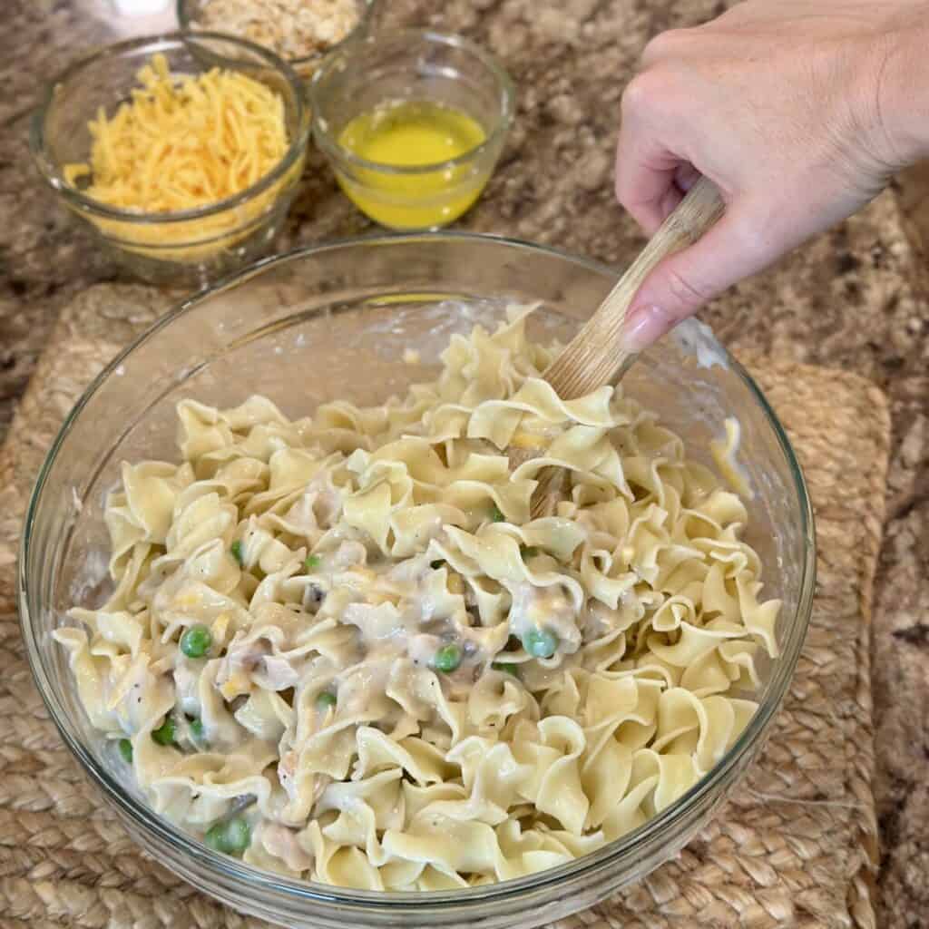 Folding noodles in the filling for old fashioned tuna noodle casserole.