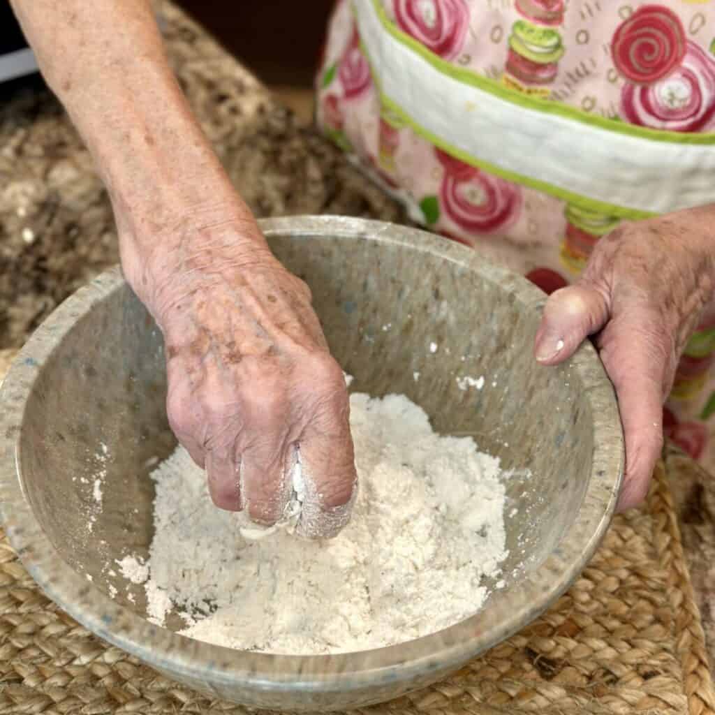 Cutting shortening in flour.