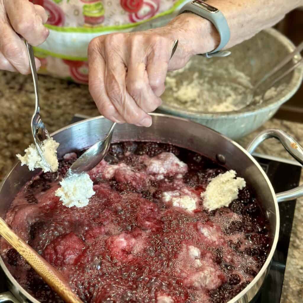 Dropping dumplings in blackberry sauce.