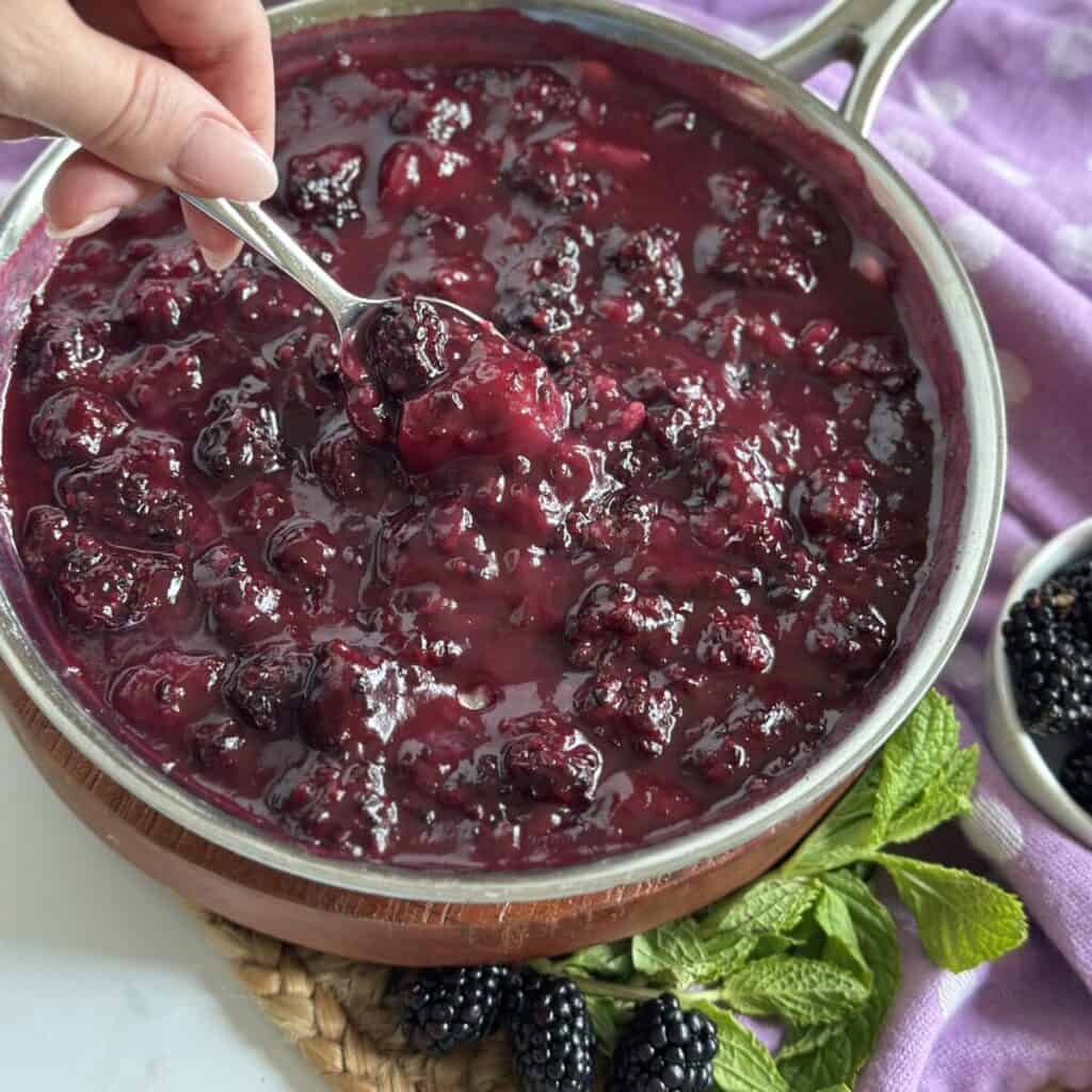 Getting a spoonful for blackberry dumplings.