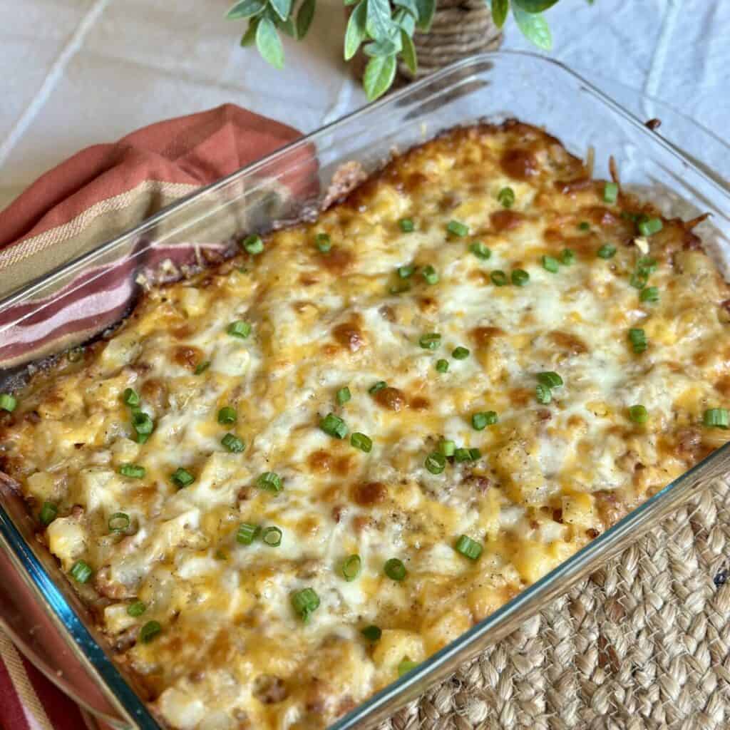 A cooked cheesy ham and potato casserole.