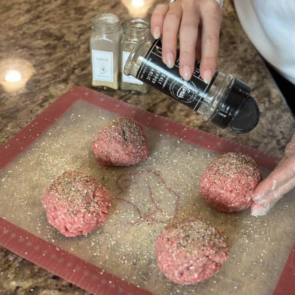 Seasoning ground beef.