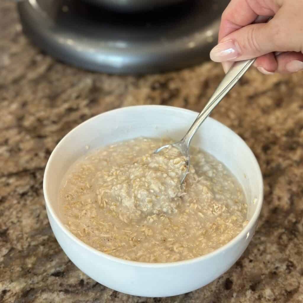 Mixing together oatmeal and water in a bowl.