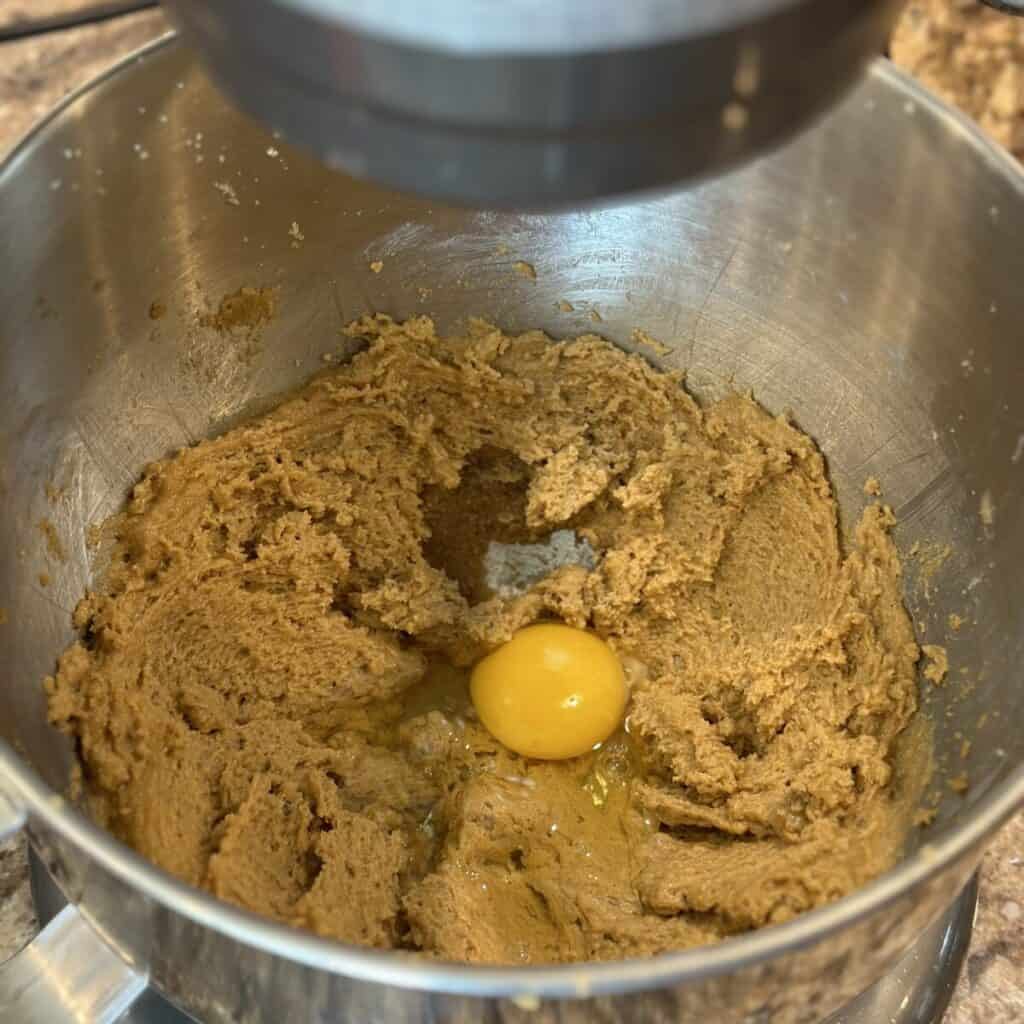 Adding eggs to oatmeal cake batter.