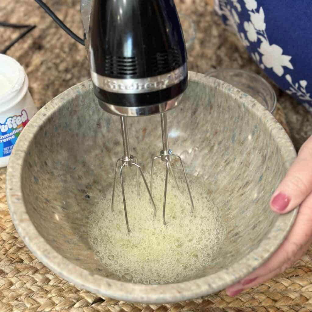 Whipping egg whites in a bowl.