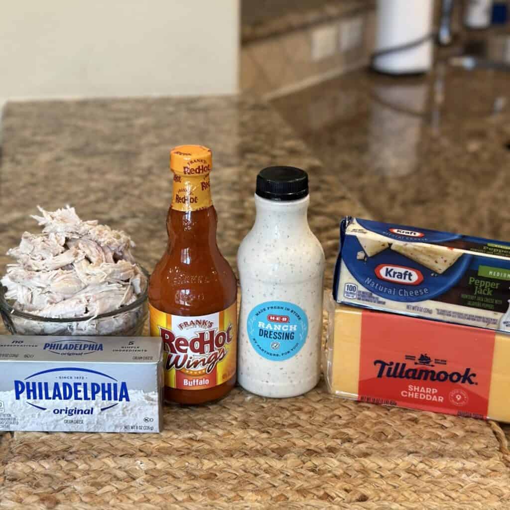 The ingredients to make slow cooker buffalo chicken dip.