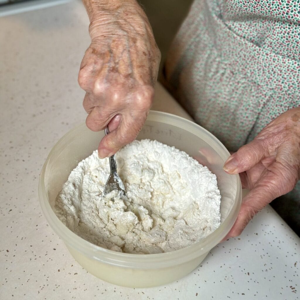 Whisking together flour and sugar.