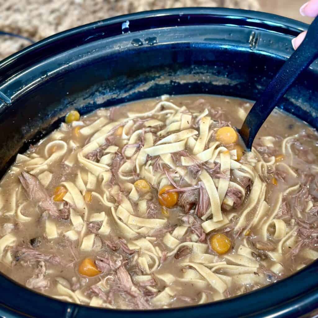 A crockpot full of beef and noodles.