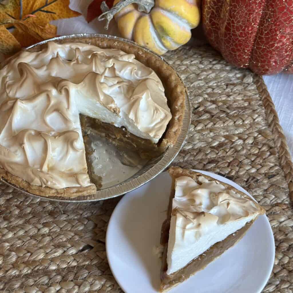 A slice of butterscotch meringue pie on a plate.