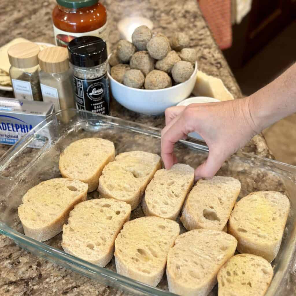 Bread in a pan for meatball casserole.