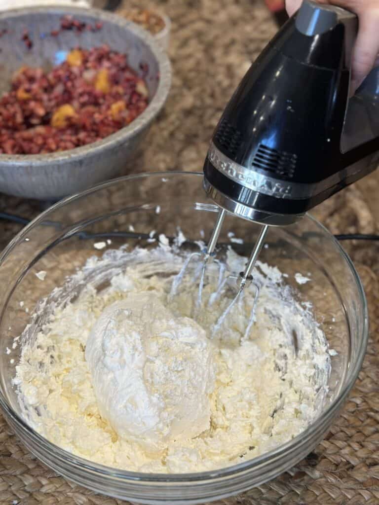 Whipping cream cheese and cool whip in a bowl.